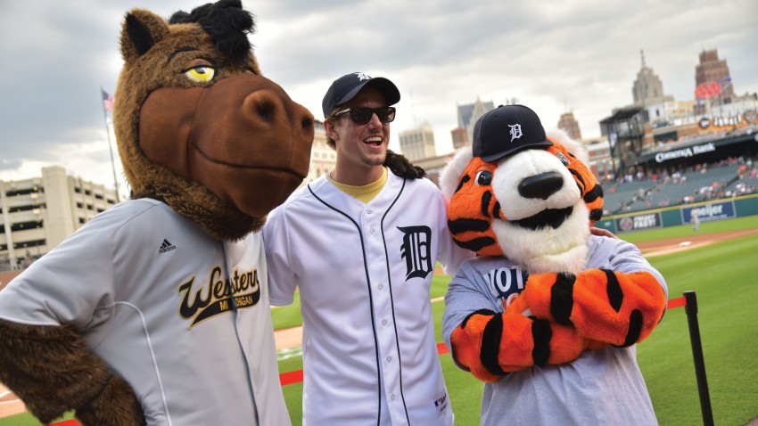 Image of Danny DeKeyser posing in stadium with Buster Bronco and Tiger mascot