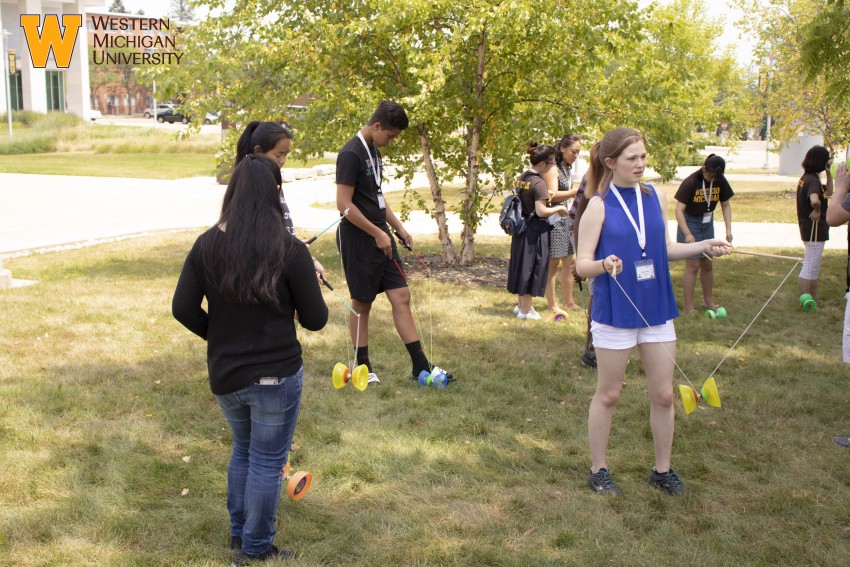 Students playing outside with Chinese yo-yos