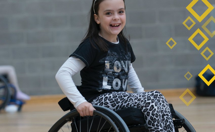 child playing wheelchair basketball