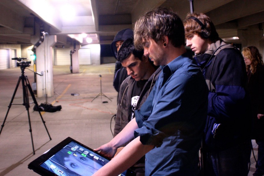 Students looking at video equipment onset in a parking garage