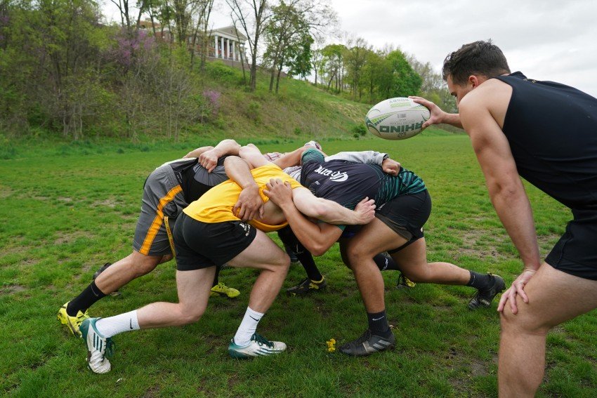 The rugby team practices a scrum.