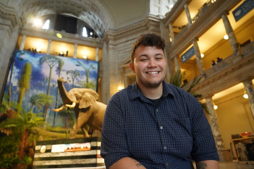 Tre Goodhue sits in the rotunda of the Smithsonian National Museum of Natural History.