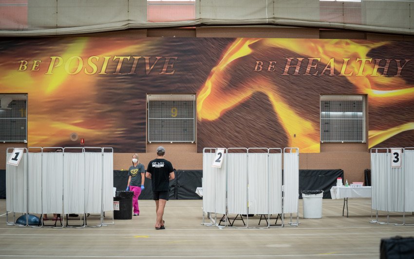 Astudent walks to one of the numbered COVID-19 testing stations.