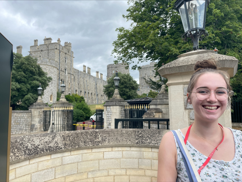 Abbie Lindblade stands at a gate outside Windsor Castle.