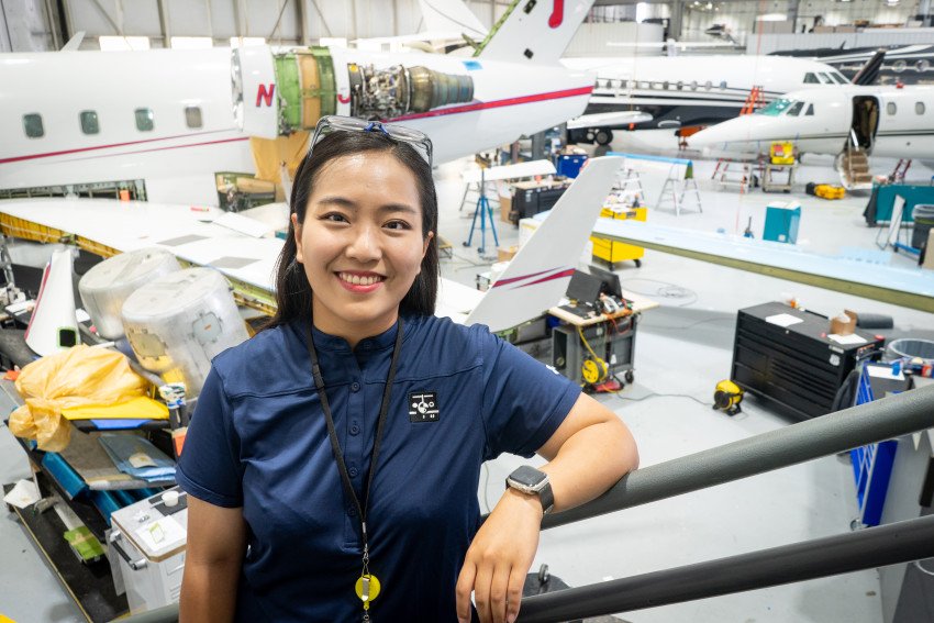 Yewon Lee stands in a room full of airplanes.