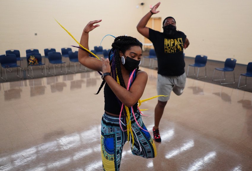 Students dance in a studio.