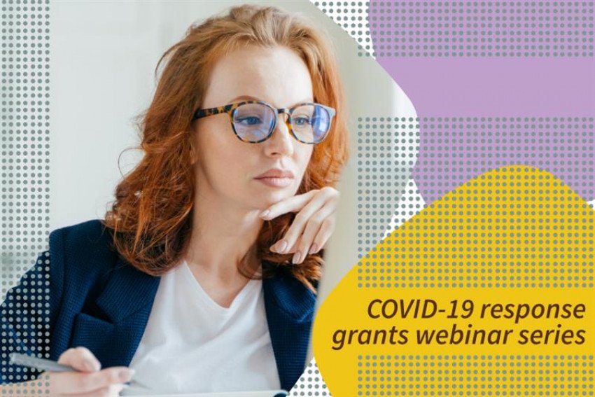 Woman sitting at desk holding pen in hand. "COVID-19 response grants webinar series"
