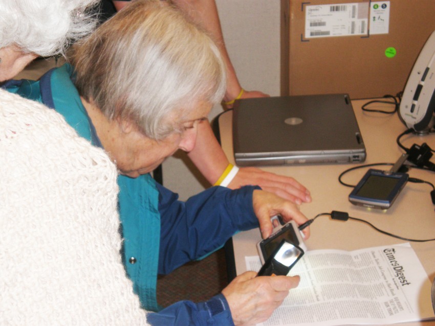 Woman using low vision device.