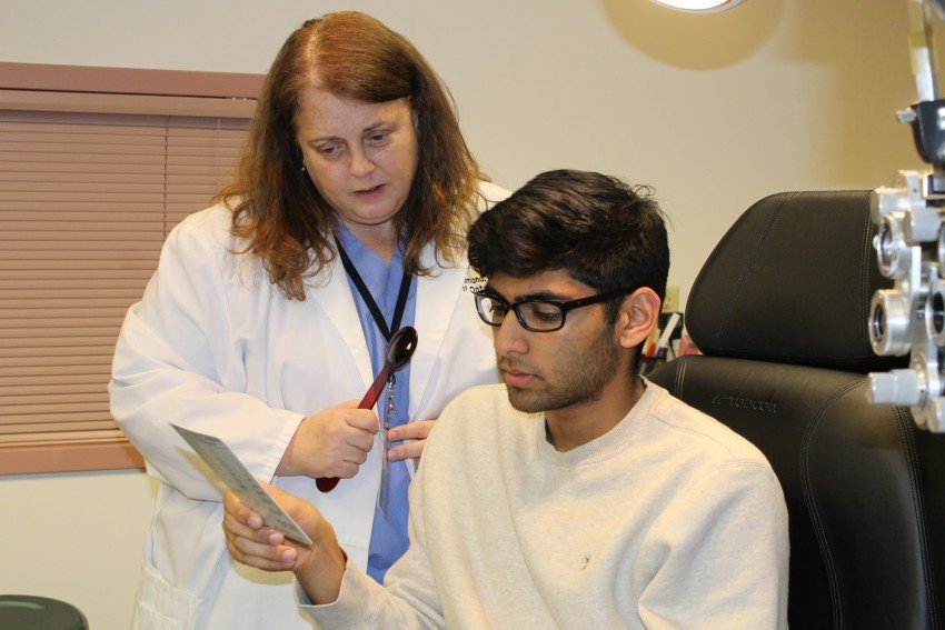 Optometrist giving an eye examination.