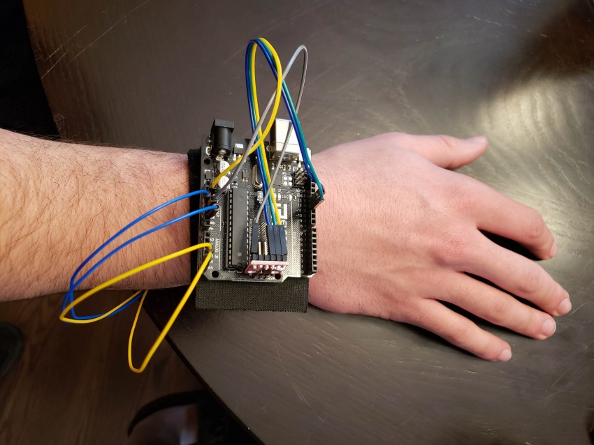 Someone wears a "biomedical wearable for narcolepsy" on their wrist.