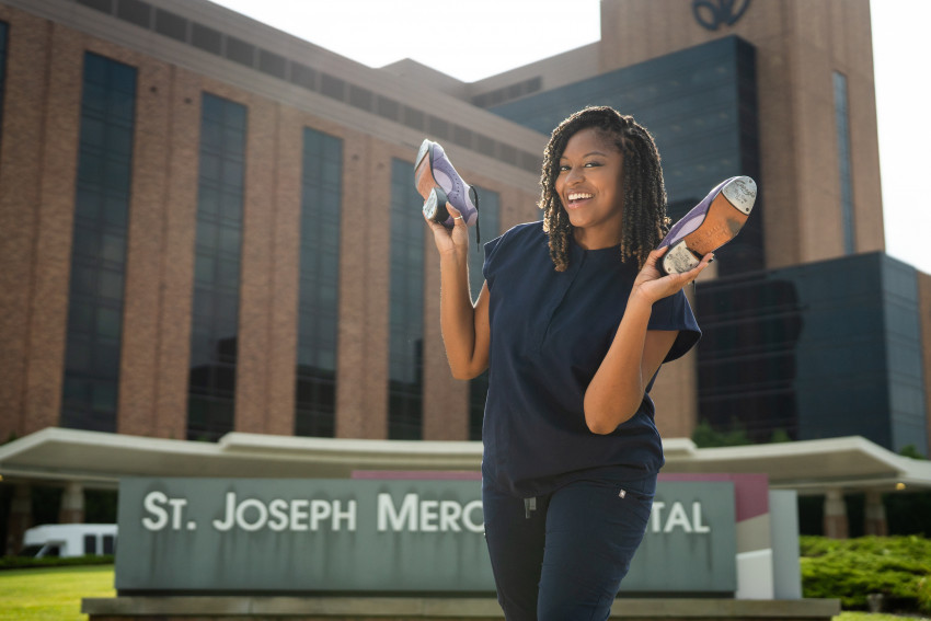 Kendall Owens holding her dancing shoes outside St. Joseph Mercy Hospital.