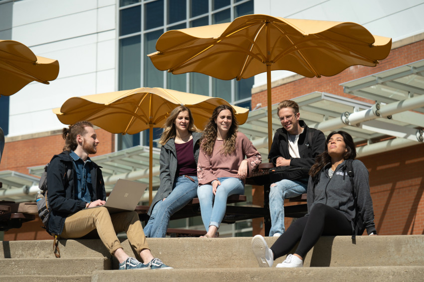 Students sitting outside on campus.