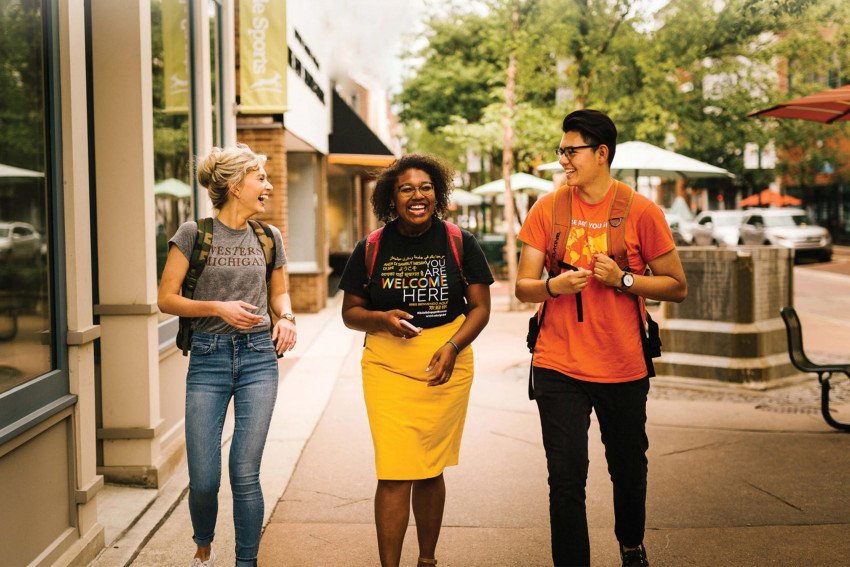 Three students walking in downtown Kalamazoo together.