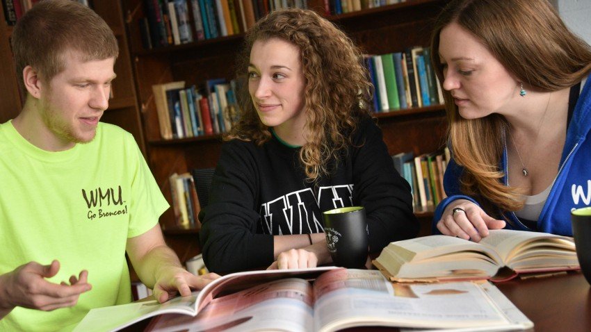 Students discussing a book
