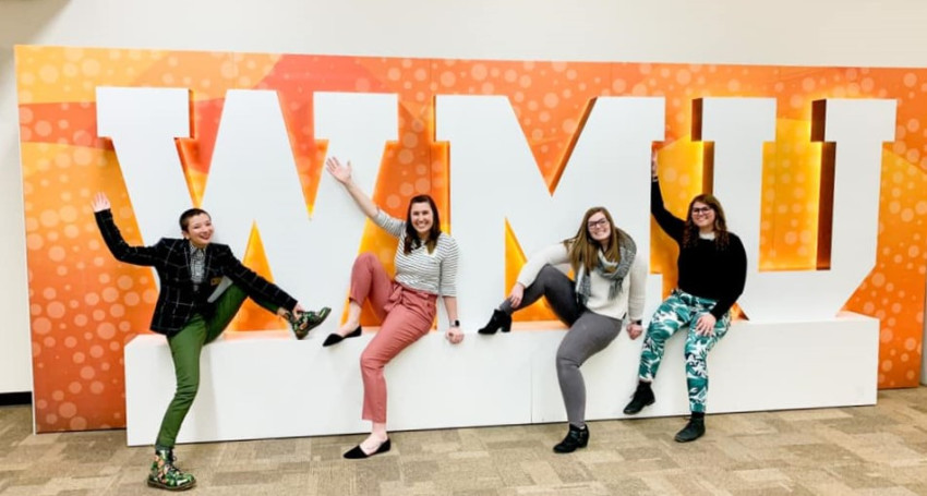 HESA Students pose in front of WMU sign
