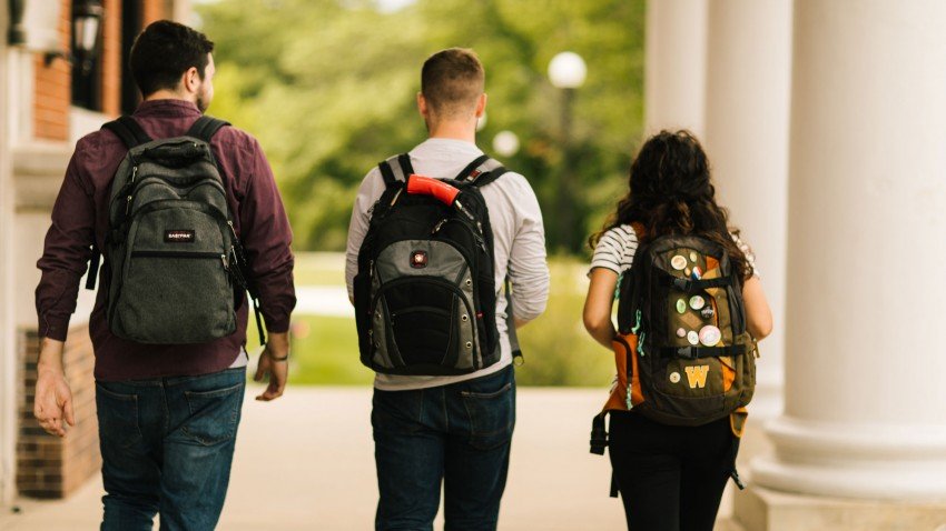 Photo of three WMU students wearing backpacks.