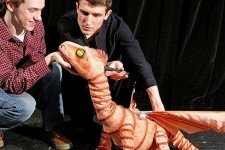 Puppeteer and an actor rehearsing with the baby dragon puppet.