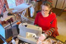 Kate MacKenzie sews in her home.