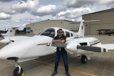 WMU Aviation Student - Trevor Thelen standing in front of a College of Aviation Piper Seminole