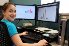 Sage Sackett at her computer working with data in ITDirect and PowerBI